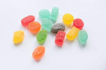 A fruit flavor of colorful sweet candy jelly bites coated with sugar isolated on white background.