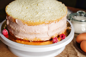 Homemade naked layered vanilla cake with whipped cream and fresh berries. Summer cake. Copy space