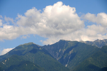Fototapeta na wymiar 夏の雲の下の木曽山脈