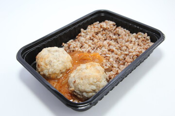 Lunch in a plastic disposable package. Meatballs with buckwheat and sauce