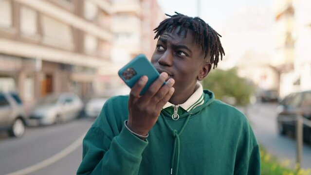 African american man smiling confident talking on the smartphone at street