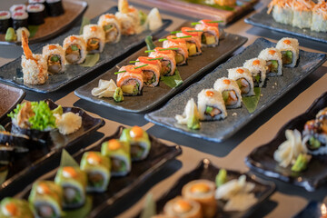 Overhead, Japanese sushi food Maki rolls with tuna, salmon, shrimp, crab, and avocado. © Sravan Chandran