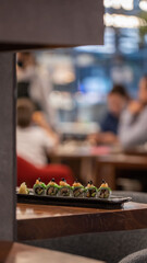 Overhead, Japanese sushi food Maki rolls with tuna, salmon, shrimp, crab, and avocado.