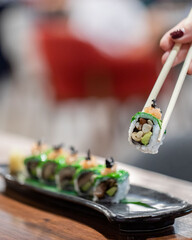 Overhead, Japanese sushi food Maki rolls with tuna, salmon, shrimp, crab, and avocado.