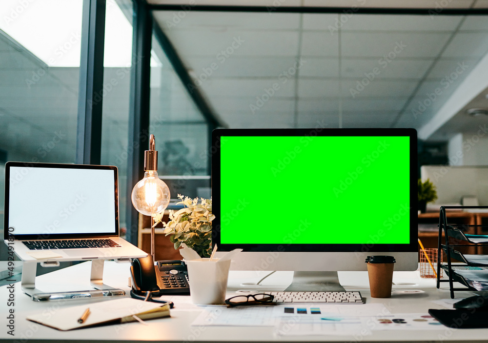 Poster Ready to take this business online. Shot of a desktop computer with a green screen on a table inside of a office during the day.