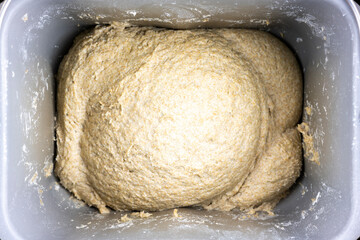 The kneading dough in a bread machine. The making bread. Top view.