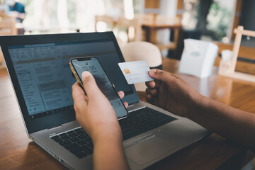 Business Credit Banking and Online Shopping Service, Close-Up of Business Woman Hands Using Credit Card for Paying Online Shopping on E-Commerce Web in Coffee Shop. Shopping Payment Via Credit Card