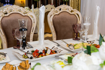 Glasses on the table for the bride and groom. A luxurious reception for a wedding celebration.