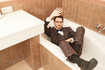 fashionable man lying in bath