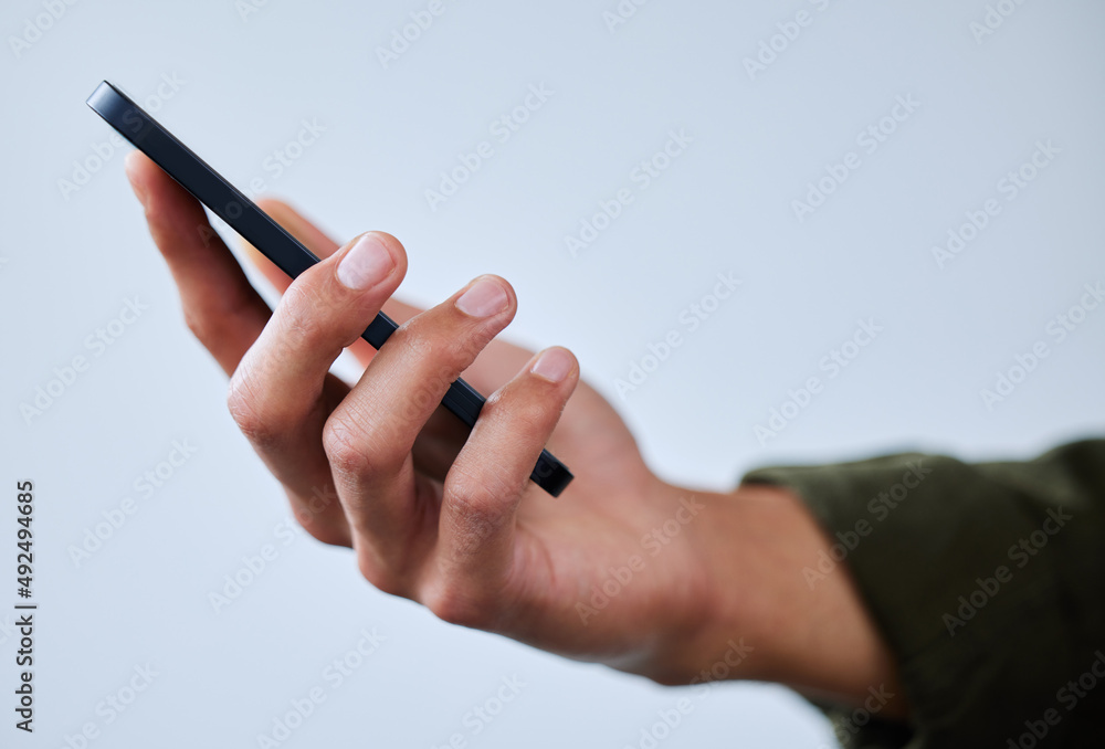 Poster One device that keeps me connected to it all. Closeup shot of an unrecognisable man using a cellphone against a white background.