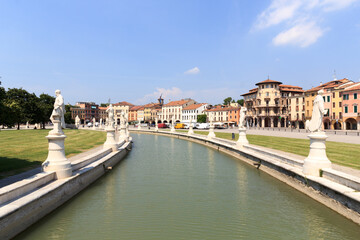 Large square Prato della Valle with canal and statues in Padua, Italy