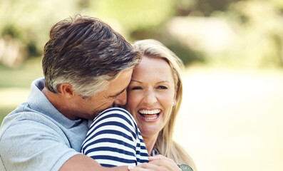 His love for her is clear for all to see. Cropped shot of an affectionate mature couple enjoying a day in the park.