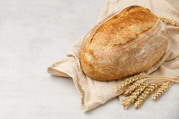 Fresh rustic sourdough bread on a towel, top view. French bread. 