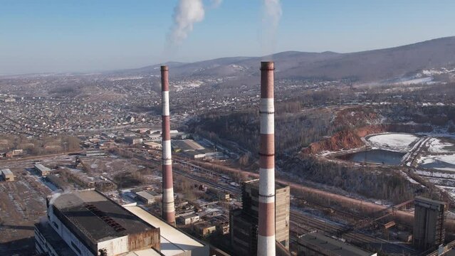 View of a working thermal power plant, smoke from a chimney, video filming from the air
