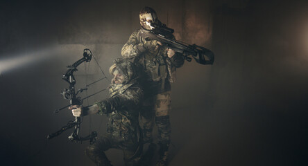 Fototapeta premium apocalypse fighters. a girl with a bow and a guy with a crossbow.