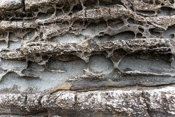 texture of porous stones on the beach, nature, natural phenomena, brown gray stones