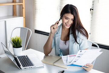 Woman holding bill with smile.