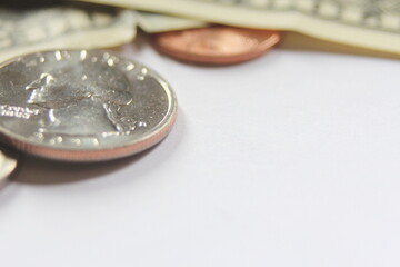 dollar bills and coins Spread them on a white background.