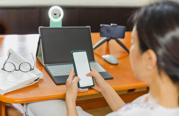 Woman checking mobile phone before working online broadcasting live.