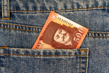 Banknote of five hundred Hungarian forint in jeans pocket close up. 