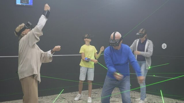 Portrait of happy family after using virtual reality glasses in the quest room. High quality 4k footage