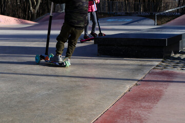 Obraz premium Children on a scooter on a rollerdrome.