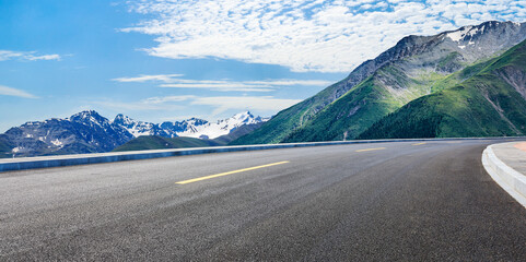Asphalt road and mountain with beautiful sky clouds under blue sky