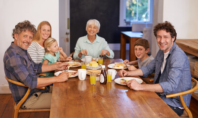 Good food and family - a recipe for happiness. A portrait of a happy multi-generation family having breakfast together at home.