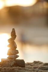 Fototapeta na wymiar Stack of stones on beach against blurry background