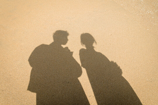 Shadow of a couple on the beach