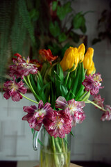 beautiful tulips and roses in a vase. spring flowers