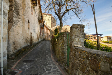 A narrow street among the old stone houses of Rocca Cilento, town in Salerno province, Italy.	