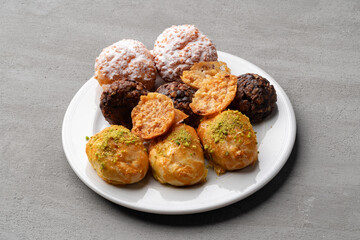 Profitroles on white plate on stone table