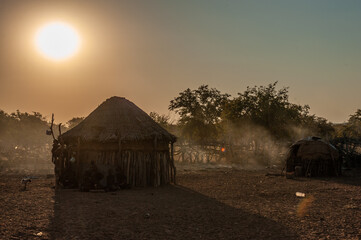 The traditional village of a Himba Tribe at sunset, in the Northwest of Namibia.