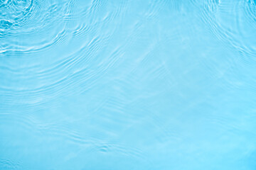 Transparent blue colored clear water surface texture with ripples, splashes and bubbles. Abstract...