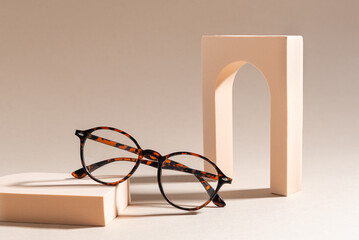 Trendy Eyeglass frame on beige Background, trendy Still Life Style. Tortoiseshell frame glasses....
