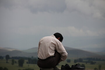 man looking at the mountains