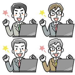 パソコンの前でガッツポーズをするビジネスマン