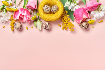 Easter creative composition. Spring flowers, Easter egg and butterflies on pink background. Easter greeting card
