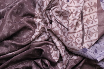 the texture of the hijab patten fabric. Patten scarf. Hijab with abstract and leaf motifs. gray, purple, light brown