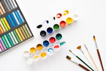 Flat composition set of artistic tools. Brushes, paints, pencils, pastels for drawing. Place for text.