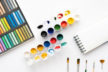 Flat composition set of artistic tools. Brushes, paints, pencils, pastels for drawing. Place for text.