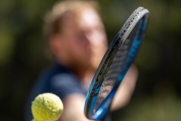close up of Amateur reaching for a tennis ball while playing tennis in Melbourne, Australia 