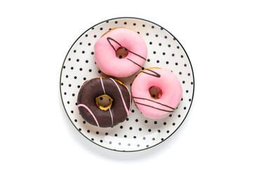 Classic chocolate, strawberry donut on white round plate with black peas isolated on white...