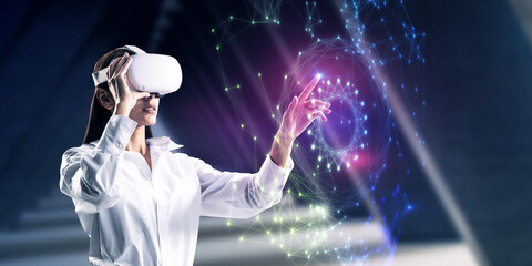 Attractive young caucasian businesswoman with VR glasses using abstract polygonal sphere on blurry...