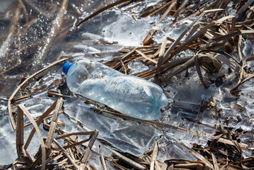 Plastic bottles on white snow.