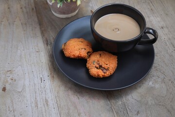 Wade, traditional Indian food on the black plate with a cup of coffee