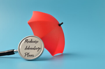 Red toy umbrella and stethoscope with text MEDICARE ADVANTAGE PLANS