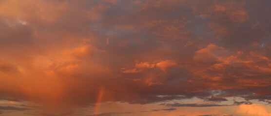 Sunset sky with clouds and rainbow - 492518224