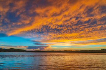 Fototapeta na wymiar Sunrise by the bay with cumulonimbus clouds